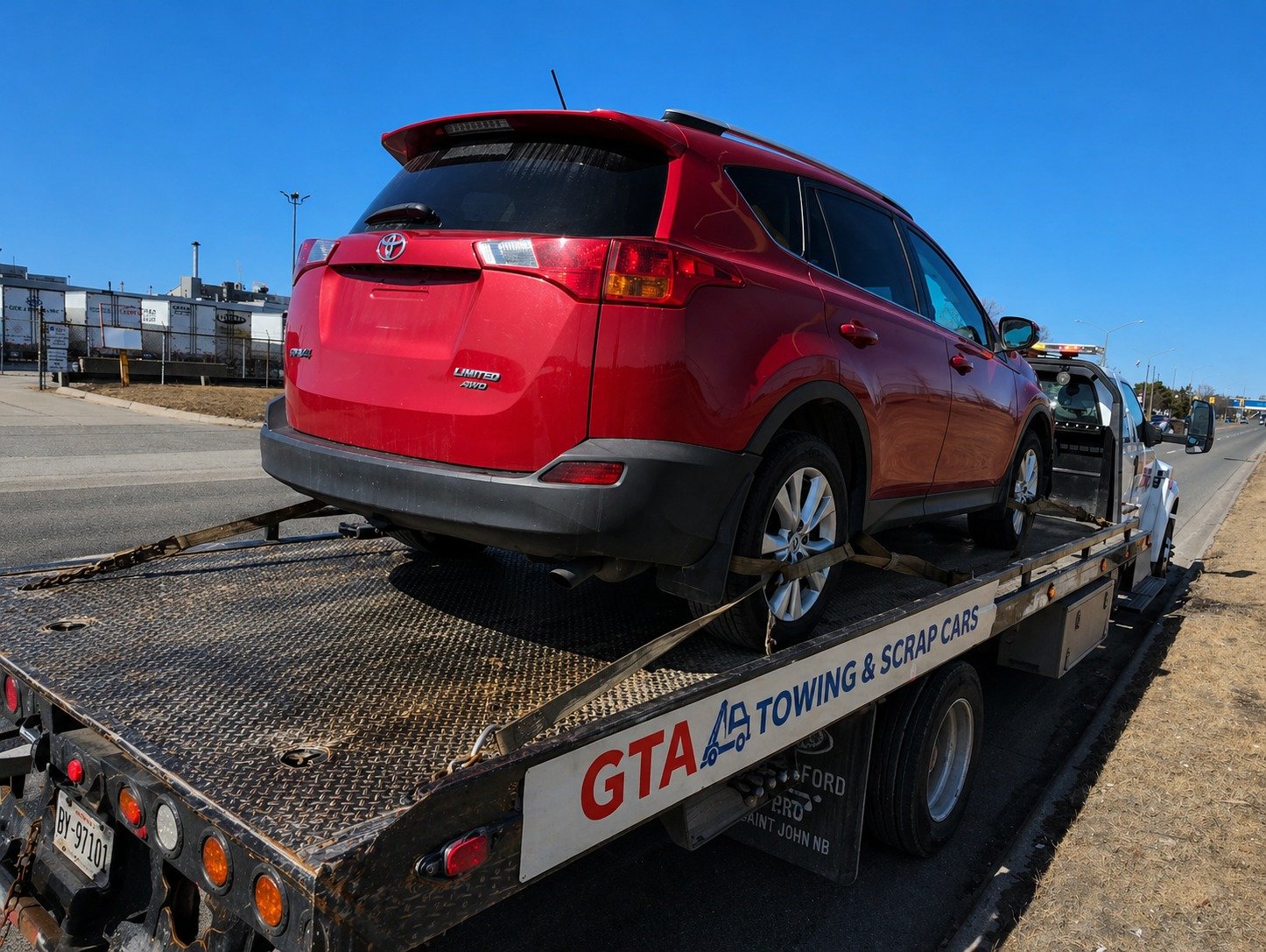 Wrecked red SUV loaded on GTA Towing and Scrap Cars flatbed truck for scrap car removal near me in Toronto