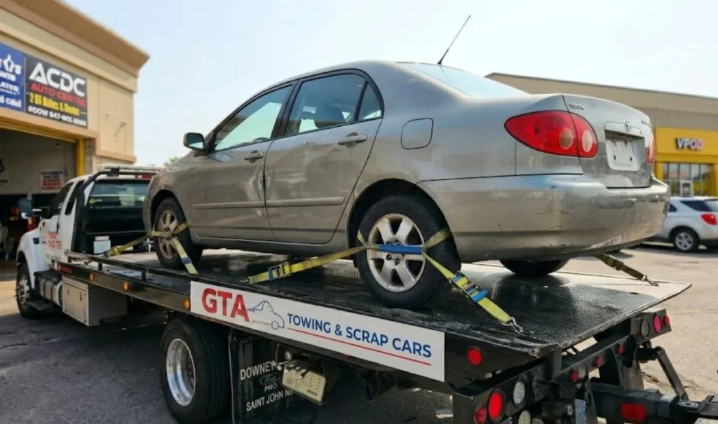 GTA Towing & Scrap Cars flatbed truck securing an old vehicle for professional scrap car removal and recycling services in the Greater Toronto Area.